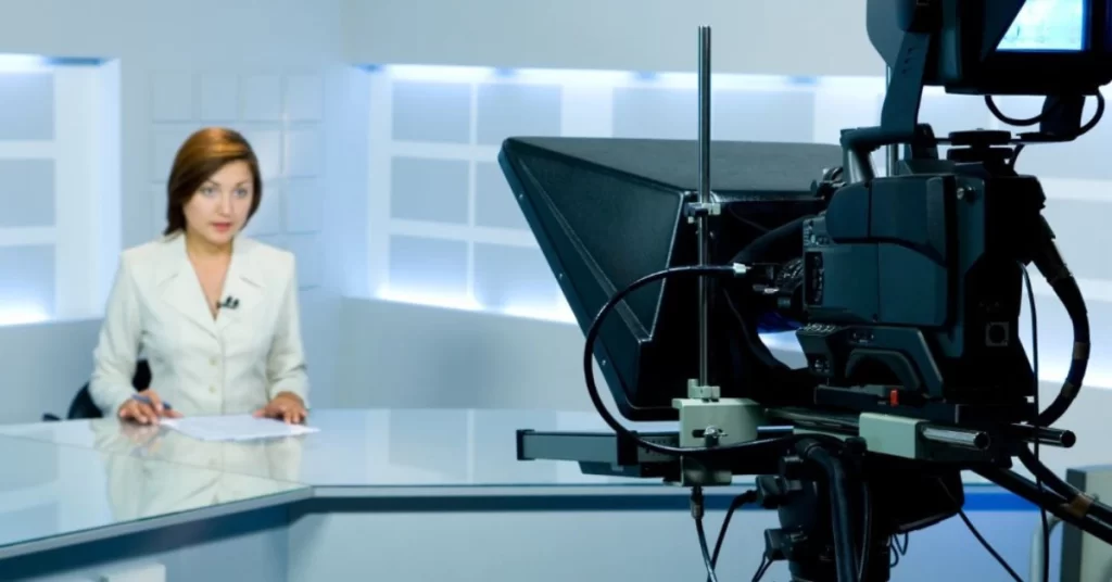 News anchor in studio with a camera and virtual teleprompter setup