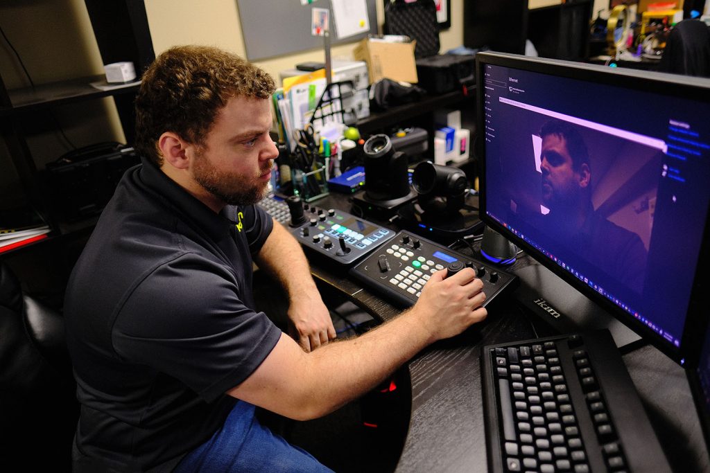 Operator using a PTZ camera controller