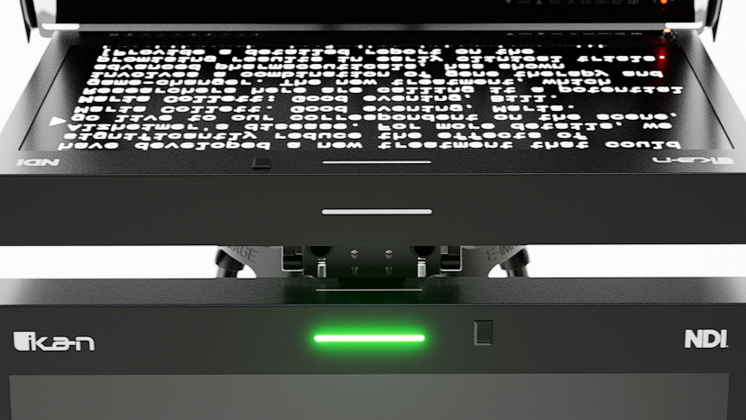A+ Dual Tally Lights M19W-NDI Close-up of the 19-inch widescreen NDI talent monitor attached below the Ikan PT419W-NDI-TMN teleprompter via a 15mm rod system, displaying a sample feed with green tally light illuminated, and visible input buttons for NDI, SDI, HDMI, and more.